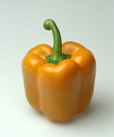 an orange bell pepper on a white background