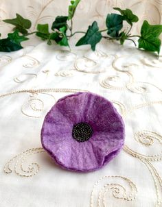 Lilac Sparkle Poppy Flower Pin Corsage Brooch Womens or Wedding Fashion Handmade Felt. A beautiful addition to an outfit in any season. Made from soft merino wool fibres, in my studio in the Midlands, UK. The oh so pretty lilac colour is enhanced by sparkle fibres being trapped within the wool during the wet felting process.   Variegated seed beads which slightly change colour according to the light complete the focal point and it is attached by a secure pin fastening. All the felt at Penny Jane Designs is laid from wool fibres, hand rolled and then decorated.   The standard therefore is much higher and more interesting than factory made felt.   Size is approximately 8/9cm in diameter.  Your actual flower may vary slightly from the picture but will still be beautifully crafted. Thank you f Purple Poppy Pin, Pin Corsage, Lilac Colour, Lilac Color, Wedding Fashion, Flower Pins, Wet Felting, Handmade Felt, Poppy Flower