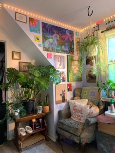 a living room filled with lots of plants and pictures