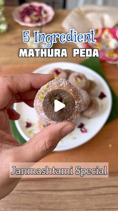 a person holding a donut in front of a plate with sprinkles on it