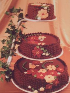 three tiered chocolate cake with flowers on it