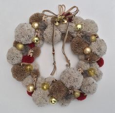 a wreath made out of pom - poms and bells