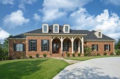 a large brick house with columns and windows