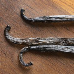 two pieces of wood that have been used to make an ear plugs on a wooden table