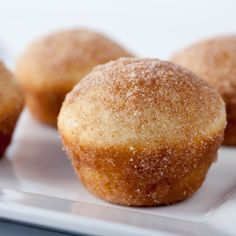 three sugar covered donuts sitting on top of a table