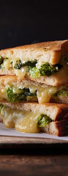 two grilled cheese and broccoli sandwiches stacked on top of eachother