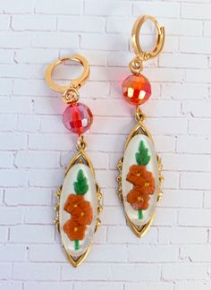 Fascinating vintage relief Lucite cabochons mounted on high-end sturdy stamped brass pieces with lustrous faceted beads for a little added shimmer. Classic versatile earrings that will complement so many wardrobe options. If these caught your eye, you may also like the Bluebell https://etsy.me/35X8fJg or the Chrysanthemum https://etsy.me/3CIEHv1 These make a special gift too! Thanks for looking! Vintage Handmade Brass Clip-on Earrings, Handmade Vintage Brass Clip-on Earrings, Handmade Adjustable Vintage Clip-on Earrings, Handmade Retro Gold Earrings, Vintage Enamel Flower Earrings, Vintage Czech Glass Matching Earrings, Vintage Gold Flower Earrings With Enamel, Vintage Copper Dangle Jewelry, Retro Earrings With Vintage Charm For Gift