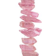 pink crystals hanging from a string on a white background