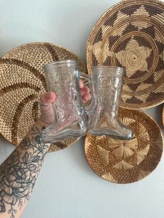 two people holding up their glasses in front of some woven placemats and wicker baskets