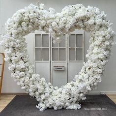 a large heart shaped wreath with white flowers