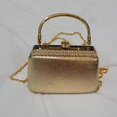 Lovely small vintage gold box purse with chain and metal handle.  The purse exterior is gold faux leather, and the top metal frame is decorated with rhinestones.   The purse has a small metal handle that can be folded and hidden inside the bag.  n excellent pre-owned condition.  Free shipping will be by least costly method (usually USPS Ground).  Buyers may choose to pay for a different method. Cheap Chic Gold Box Bag, Cheap Square Gold Box Bag, Cheap Vintage Gold Wallets, Gold Purse, Box Purse, Gold Box, Wedding Bag, Mini Purse, Suitcases