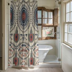 a bathroom with a shower curtain, tub and window in it's center area