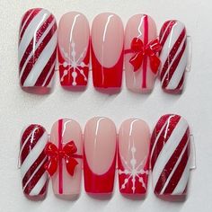 sparkly candy cane design on thumb and pinky  red french tip on index and middle  red bow on ring finger  perfect for Christmas :)  What comes in your package?? - your 10 piece nail set  - mini nail file  - mini buffer  - nail glue  - cuticle pusher  - adhesive tabs  - cuticle oil  - stickers  Keep in mind everything but the nails are free and will be given if available. There have been times where I run out and not able to order more before I ship out your order.  Please understand that the design will not be an exact copy since it is handmade. If you want a custom size just enter it in the personalization box :).  Disclaimer: Once the item is shipped, I am not responsible for any damages on the items. Please make sure to measure your nails correctly if unsure, let me know and I will help 3d Candy Cane Nails, Red Peppermint Nails, Christmas Nails With Stickers, Little Debbie Christmas Tree Nails, Candy Cane Nails Christmas, Christmas Nails Simple Red, Christmas Nails Candy Cane, Christmas Bow Nails, Red Nails Christmas