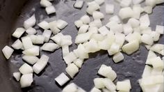 diced onions are being cooked in a skillet