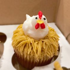 a cupcake decorated with noodles and a chicken on top