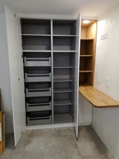 an empty closet with shelves and drawers in it