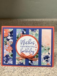 a handmade birthday card with blue and orange flowers on it, saying wishes for a beautiful birthday