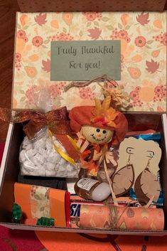 a box filled with lots of items on top of a table