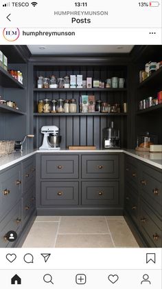 a kitchen with gray cabinets and white counter tops