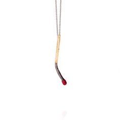 The matchstick pendant is made from a consumed match, preserving every detail of the original material. The necklace features a black chain, and a bright red tip. Each piece is made exclusively by hand, and will therefore have its own unique characteristics. 22K Gold-plated Brass, Oxidised Silver Chain, Red Enamel Minimalist Long Necklace With Lobster Clasp, Matchstick Jewelry, Vintage Long Chain Necklace With Lobster Clasp, Minimalist Gold-tone Chain Necklace With Lobster Clasp, Red Gold-plated Necklace With Lobster Clasp, Horoscope Necklace, Unique Characteristics, Black Chain, Bracelet Collection