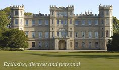 a large building with lots of windows on top of it's sides in the middle of a green field