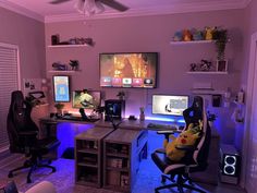 a living room filled with furniture and a flat screen tv mounted to the wall next to a computer desk