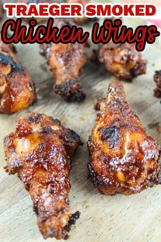 some chicken wings are sitting on a cutting board with the words traeger smoked chicken wings