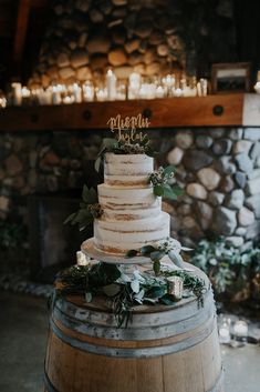 a wedding cake sitting on top of a barrel