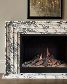 a marble fireplace with flames burning in it