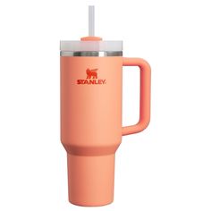 an orange travel mug with a straw sticking out of the lid and handle, on a white background