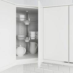 an open cabinet with dishes and cups in it