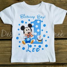 a mickey mouse birthday shirt with the number one on it and cupcakes in blue