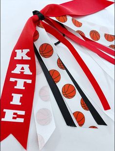 three ribbons with basketballs on them are tied together