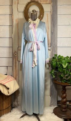 Vintage 1980s pastel nylon maxi peignoir set, Vanity Fair nightgown and robe set, XS. This vintage baby blue nylon nightgown features a sleeveless tank style V-neck top with a floral appliqué at center in lavender and white and a maxi skirt. The matching robe features lavender and white around the collar with a floral appliqué on one side, long sleeves trimmed in lavender and white, lavender and white sash that ties at the waist, and 1 side-seam pocket. Condition: Great condition; no flaws to note. Both the nightgown and robe have original tags;  Vanity Fair  Size XS; see measurements below:   Measurements: Nightgown: Chest (taken with garment lying flat from pit-to-pit): 15" Waist (taken with garment lying flat from side seam-to-seam): 20" Length from middle back to bottom: 43" Robe: Ches Blue Spring Robe For Loungewear, Light Blue Long Sleeve Nightgown For Spring, Blue Spring Robe For Home, Blue Robe For Spring Daywear, Blue Home Robe For Spring, Blue Spring Home Robe, Blue Maxi Dress For Spring Loungewear, Maxi Length Daywear Robe For Spring, Maxi Length Robe For Spring Daywear