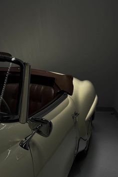 an old car is parked in a dark room