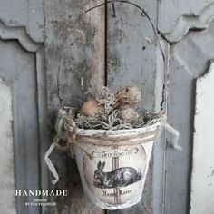 an old bucket hanging from the side of a door with mushrooms and other things in it