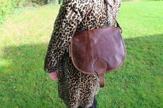 Saddle Bag Medium Large, Distressed dark brown, 3 inner compartments, External pocket, Buckled saddle bag, Rich brown vintage style, Saddle Purse Genuine leather, Durable nylon lining, Internal zip pocket, Long adjustable strap, Across body or shoulder bag, Seventies vibes handbags, Loads of room for everyday essentials  If this doesn't bring back memories! Our amazing rich brown saddle bag in genuine leather is just our very favourite, in our distressed leather too for added character.  The retro look we love!  Lightweight and roomy!   DIMENSIONS Top to bottom 10 inches  Width 11ins 5.5 x 7 ins front pocket inside flap and 1 ins depth Strap length 50 ins max and width 1ins Internal compartments x 3 - one zipped 7 x 6ins 2 flap pockets inner 5ins x 5ins Brown Saddle Bag For Daily Use, Classic Brown Saddle Bag, Brown Leather-lined Saddle Bag, Brown Saddle Shoulder Bag, Vintage Brown Saddle Bag With Leather Backing, Vintage Brown Saddle Shoulder Bag, Brown Satchel Saddle Bag With Leather Lining, Brown Leather-backed Saddle Bag, Vintage Brown Saddle Satchel