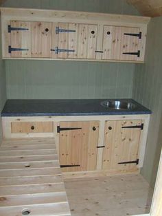 an unfinished kitchen with stairs leading up to the sink