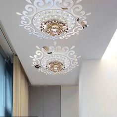 the ceiling light in this bathroom is decorated with intricate designs