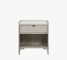 a nightstand with a white marble top and drawers