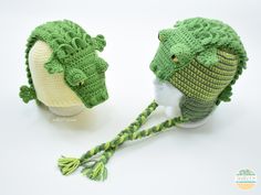 two crocheted hats with alligator heads on them