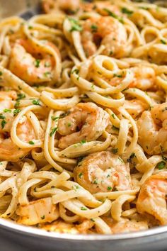 pasta with shrimp and parsley in a pan ready to be served on the table