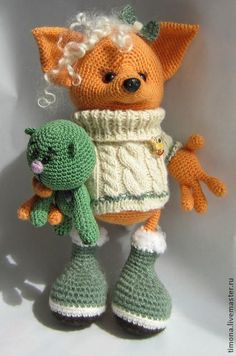 an orange stuffed animal holding a green stuffed toy