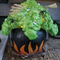 a pumpkin decorated with green leaves and eyes