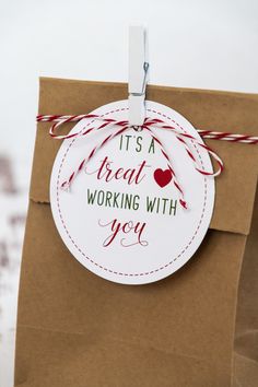 it's a great working with you tag hanging from a brown paper gift bag