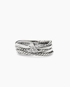 a stack of three silver rings with a diamond on the top and bottom, set against a white background