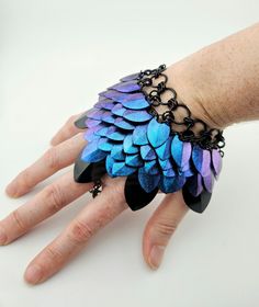 This is a unique hand armor. It is hand painted and not a color available any where else.  This particular scale color is color shifting from a blue to purple with a beautiful sparkle.   The scales are also available to purchase separately for your own projects! https://silvergriffonskies.etsy.com/listing/1655518640 The chain is 8.75" in length and can be customized if you want it longer or shorter.  At its widest point the scale maile is 5" wide and approximately 3.5" long. Including the top ch Hand Armor, Stripping Paint, Take My Money, Mermaid Scales, Stardust, Custom Color, Chemicals, Dish Soap, Mermaid