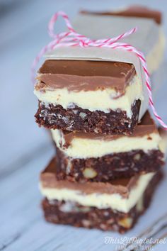 four pieces of chocolate and white cake on top of each other, tied with twine