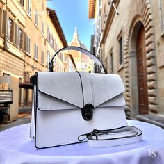 This bag has been made of the best genuine leather by local master crafters of Florence in Italy, designed for women who only accept premium Italian quality and luxury leather bags and modern Italian fashion. . Sizes: Width: 29cm/10.6 inch Height: 19cm/7.4 inch Depth: 7 cm/3.9 inch Color: White The story behind this bag: Once upon a time, in the heart of Italy's fashion capital, Florence, there was a skilled craftsman named Marco. He had inherited the art of leather-making from his ancestors and had spent his entire life mastering the skill. His leather products were known for their superior quality, classic designs, and timeless elegance. One day, Marco decided to expand his leather collection and introduced some new designs to his shop. He began making leather harnesses, folders, hip bag White Leather Bag With Leather Trim, White Textured Leather Bags For On-the-go, White Leather-handled Box Bag For Travel, White Leather Box Bag With Detachable Handle, Art Du Cuir, White Calf Leather Bag With Silver-tone Hardware, Leather Bags For Women, Handmade Leather Bags, Luxury Leather Bag