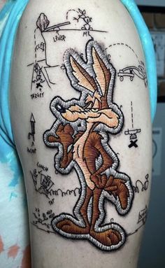 a person with a rabbit tattoo on their arm